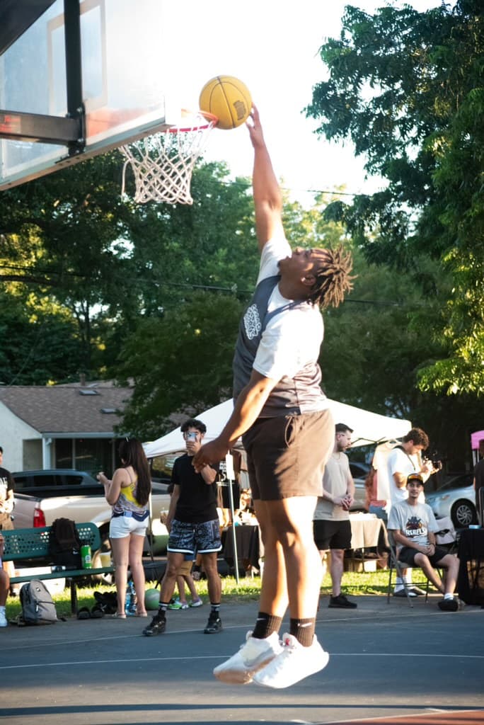 Player dunking at the Scoop Dreams 3-on-3 basketball tournament