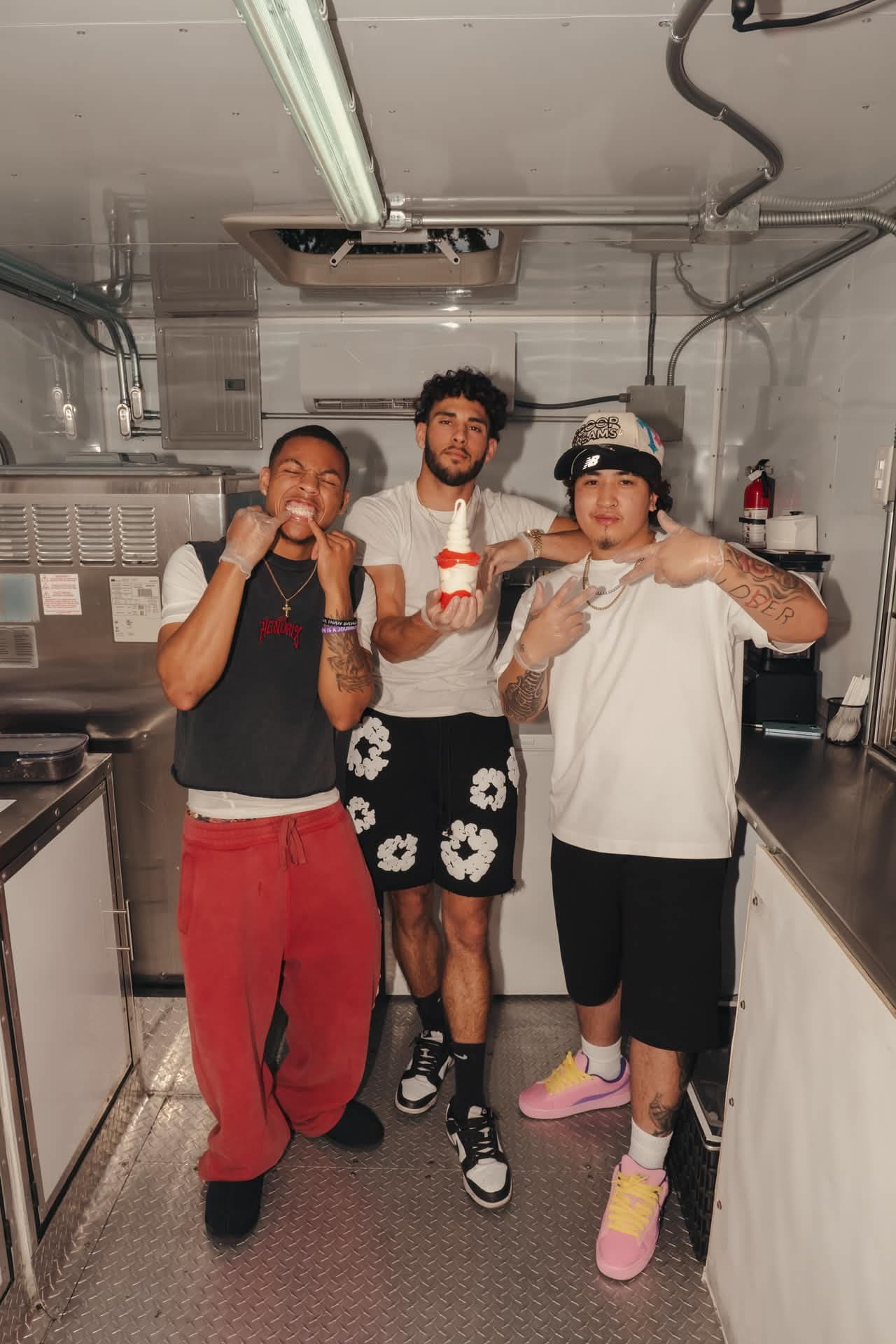 The Scoop Dreams crew posing with a soft serve cone inside the trailer
