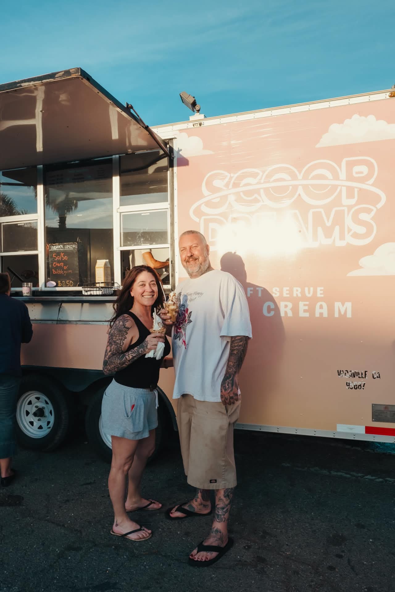 A couple posing with a sundae at the Scoop Dreams trailer in Vacaville CA