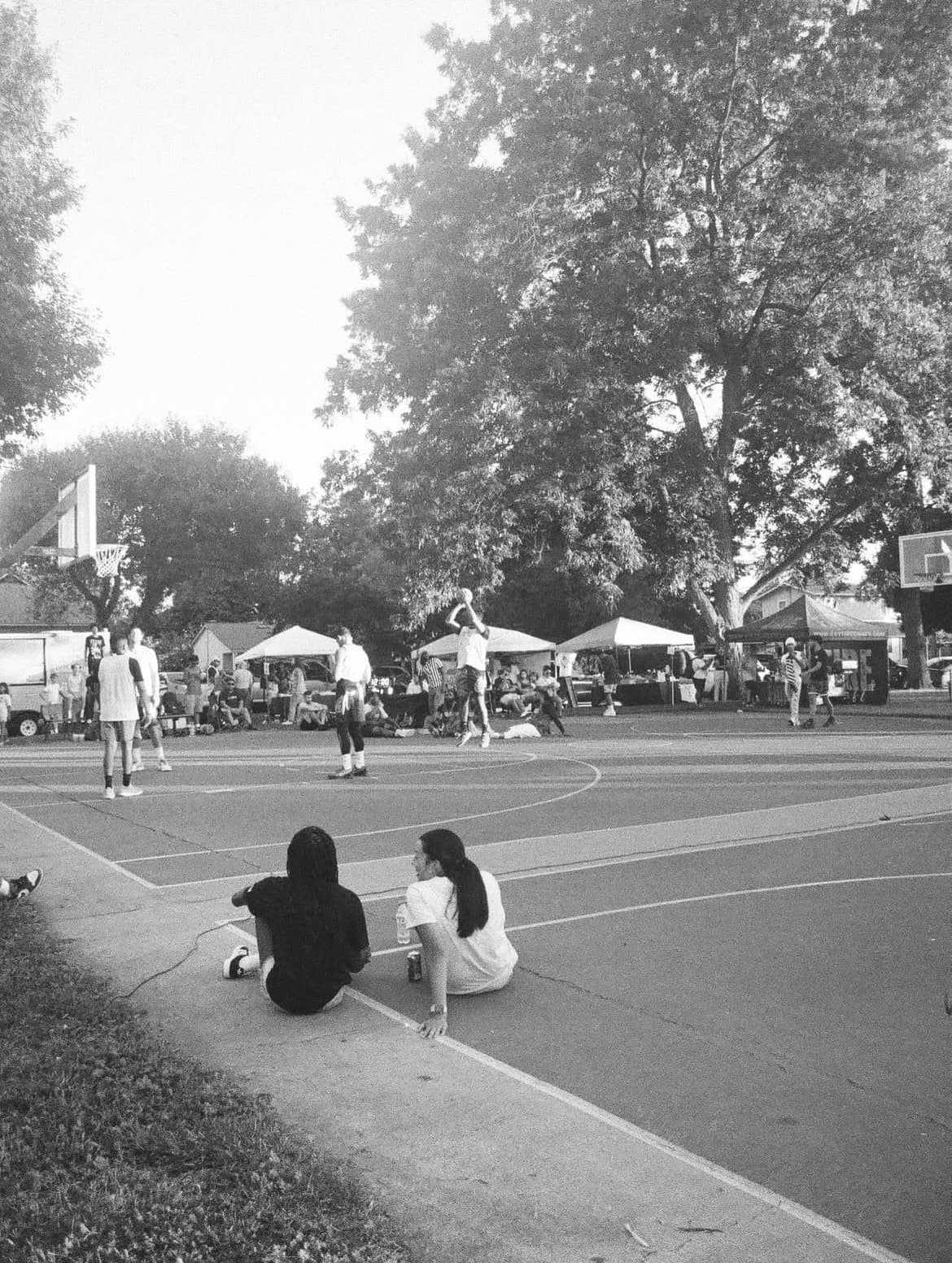 Black and white photo of spectators watching the Scoop Dreams community basketball tournament