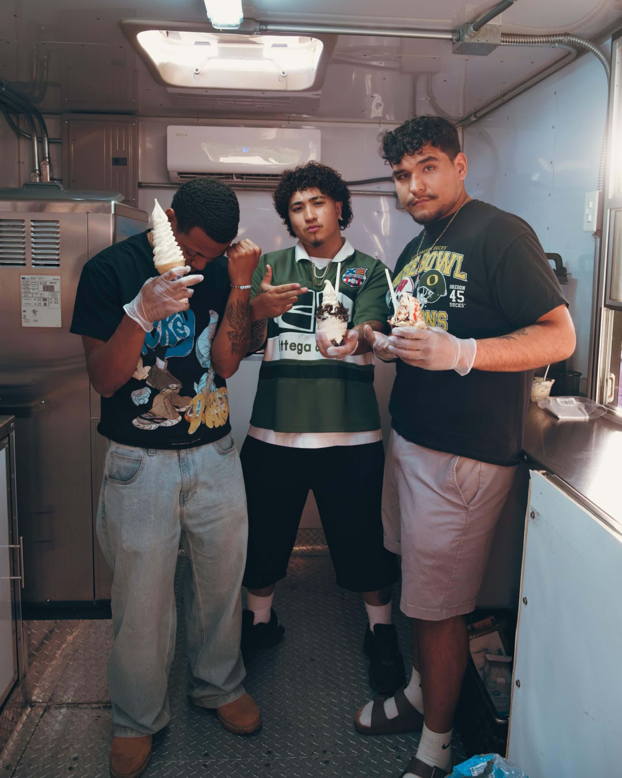 The Scoop Dreams crew posing inside the trailer holding soft serve cones
